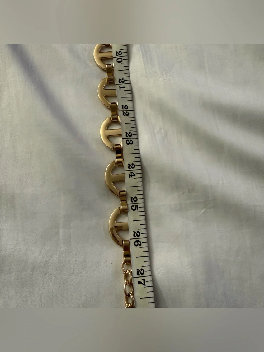 Gold tone metal chain belt with rhinestone details